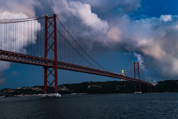 Fototapeta premium The 25th of April Bridge and the Jesus Cristo Rei Monument in Lisbon, Portugal.