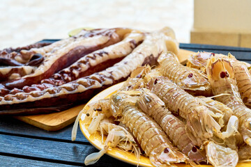 Seafood platter: Octopus, Mantis Shrimp on wooden board