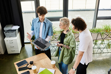 Three young professionals collaborate in an engaging office, reviewing project details