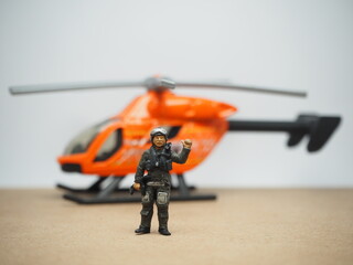 Mini toy of action figure at table with blurred background. Miniature photography concept design.