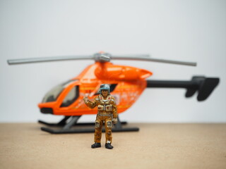 Mini toy of action figure at table with blurred background. Miniature photography concept design.