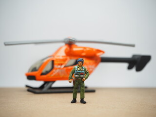 Mini toy of action figure at table with blurred background. Miniature photography concept design.