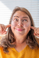 Middle aged woman 50 years old, human ear ringing, listening, acoustics Auditory System, Hearing...