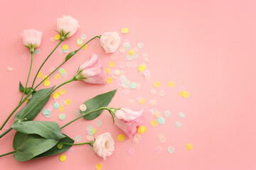 Top view image of pink flowers composition over pastel background .Flat lay