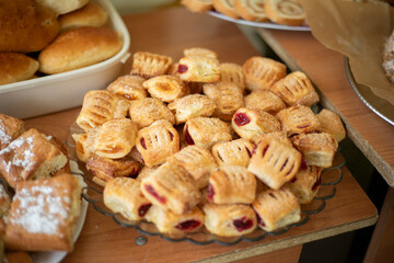 Sweet pastries are on the table. Big pies and small cookies. Homemade food. Delicious food on the tables.