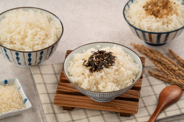 A bowl of white rice topped with rice seasonings.