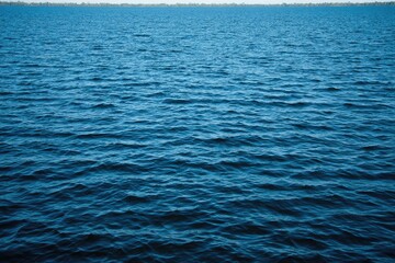 Fototapeta premium Calm, deep blue water surface, rippled texture