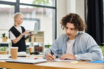 Fototapeta premium Youth engaged in focused office work while collaborating in a modern workspace