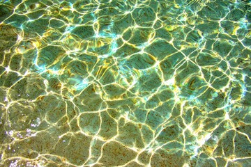 Rippled turquoise water reflecting sunlight