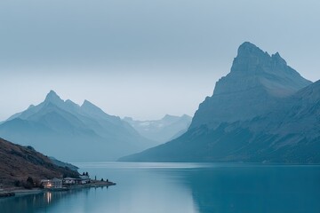 Misty mountain range reflecting on tranquil lake