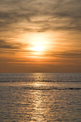 Sunset over the sea, golden light reflections and silent expanse