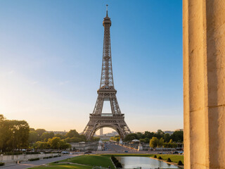 Obraz premium Beautiful view of the Eiffel Tower in Paris, France, captured during sunset with a clear blue sky and surrounding trees. Iconic travel destination and one of the world’s most famous landmarks