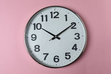 wall clock on a pink background

