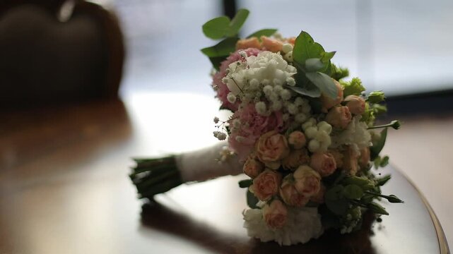 A stunning, multi-tiered wedding cake adorned with delicate pink flowers, displayed prominently at an elegant event with soft purple lighting and lush greenery. - Powered by Adobe
