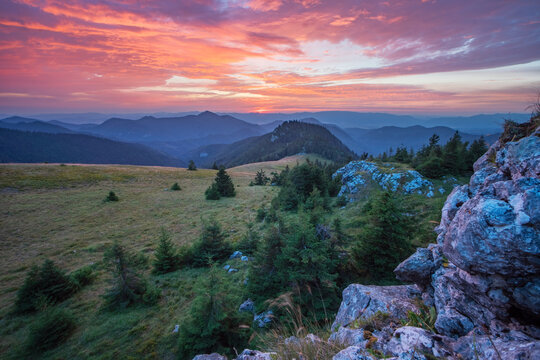 View of the sun dips below the horizon, painting the sky in vibrant hues above the rolling Velka Fatra mountains, Blatnica, &Aring;&frac12;ilina Region, Slovakia.