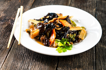 Chinese Mixed Vegetable Stir-Fry with Wood Ear Mushroom Black Fungus on dark background. Asian food. Chinese cuisine. Seafood. Vegetables