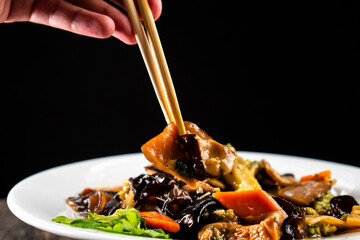 Chinese Mixed Vegetable Stir-Fry with Wood Ear Mushroom Black Fungus on dark background. Asian...
