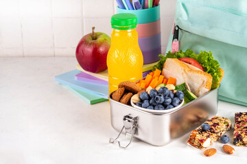 Preparing homemade balanced healthy lunch box for schooler