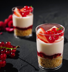 Delicious layered dessert with fresh fruit served in clear cups