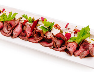 Savory roast beef platter with fresh herbs and tangy sauce for elegant dining