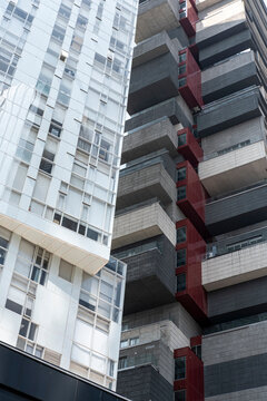 Residential facade close up in Santa Fe, Mexico City, Mexico, with alternating red and white architectural elements, symbolizing modern apartment buildings and urban contemporary housing