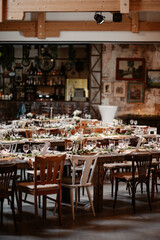 Rustic boho wedding with couple, decorations, flowers and celebration in vintage barn