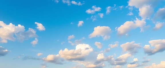 Serene morning sky, vibrant blue canvas dotted with fluffy white clouds, soft golden light, light, bright