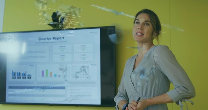 Business professional pointing pen at bar graph, generating data overlays explaining quarter report