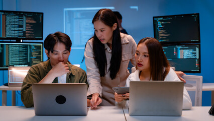 Asian software engineer or programmer team working late in development office,problem solving or algorithm of ai assistant helping for work.software developer,digital technology security concept