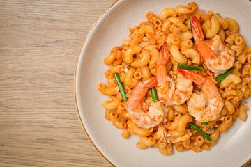 Homemade Stir fried macaroni with shrimp and egg in white plate