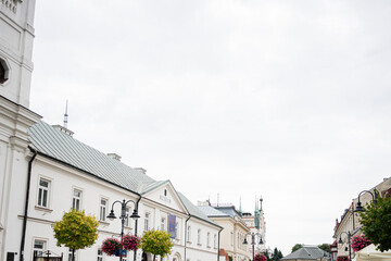 Family strolling on a picturesque street in Rzeszow, Poland during daytime
