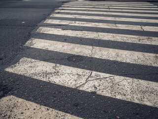 Obraz premium Abstract Urban Crossing. Textured Asphalt and Faded Stripes Perspective, Pavement Detail.