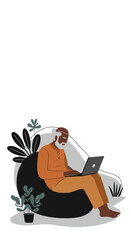 Senior man on beanbag using laptop, surrounded by plants. Modern elder engaging with technology, remote work, or comfortable digital lifestyle.