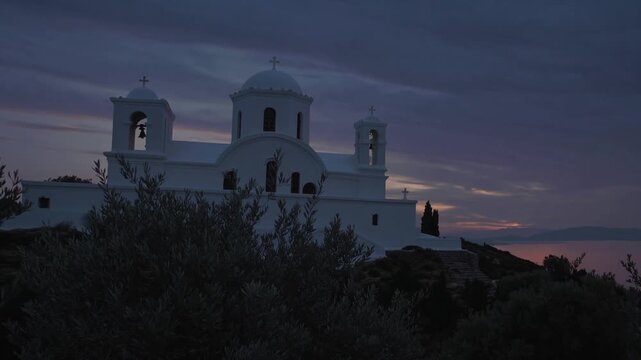 Breathtaking Sunset View of Saint Antony Church with a Majestic Steeple and Cross, Ideal for Religious Campaigns or Serene Projects.