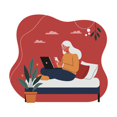 Senior woman comfortably working from home on her laptop and smartphone. Represents remote work, online communication, and modern digital lifestyle for all ages.