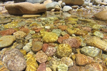 Clear shallow stream bed, colorful rocks