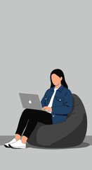 Young person working comfortably on a laptop while sitting on a bean bag chair, illustrating remote work, flexible lifestyle, or online education.