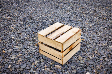 wooden box on a background of crushed stone.