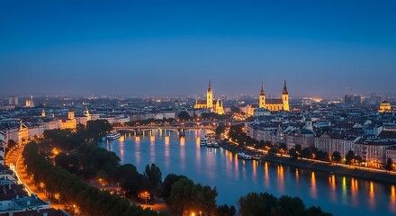 Obraz premium Panoramic view of a city at twilight, illuminated by lights along the riverbank and on buildings.