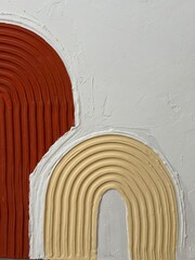 A close-up of a handmade textured 3D abstract painting with raised curved lines in orange, beige,...