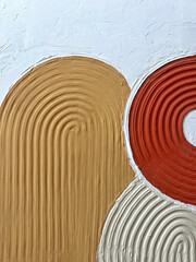 A close-up of a handmade textured 3D abstract painting with raised curved lines in orange, beige,...