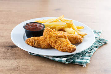 Crispy fried chicken tenders on wooden table