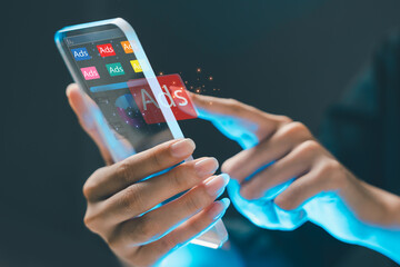 Futuristic concept of digital advertising on mobile device. A person interacts with virtual ads...