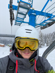 Ski Enthusiast on a Snowy Mountain Lift