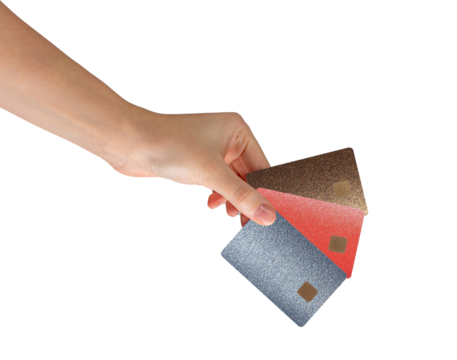 Hand holding three colorful credit cards with chip in metallic textures bronze, red, and silver.