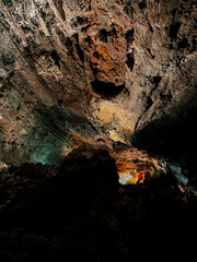 Stunning cave formations illuminated by natural light in a volcanic landscape