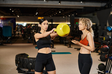 Empowered women in the gym sharing fitness tips and inspiring each other through strength training