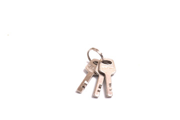 details of key ring with various door and car keys against a white background,