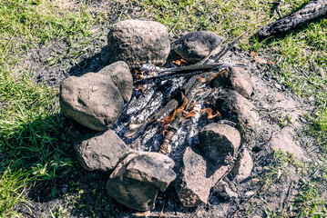 Campfire at tourist campsite, hiking tourism on weekend vacation, fire flame