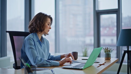 Businesswoman checking financial papers working office closeup. Serious woman